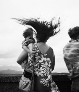 Photograph of a family standing on a bridge