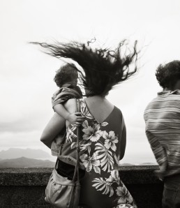 Photograph of a family standing on a bridge